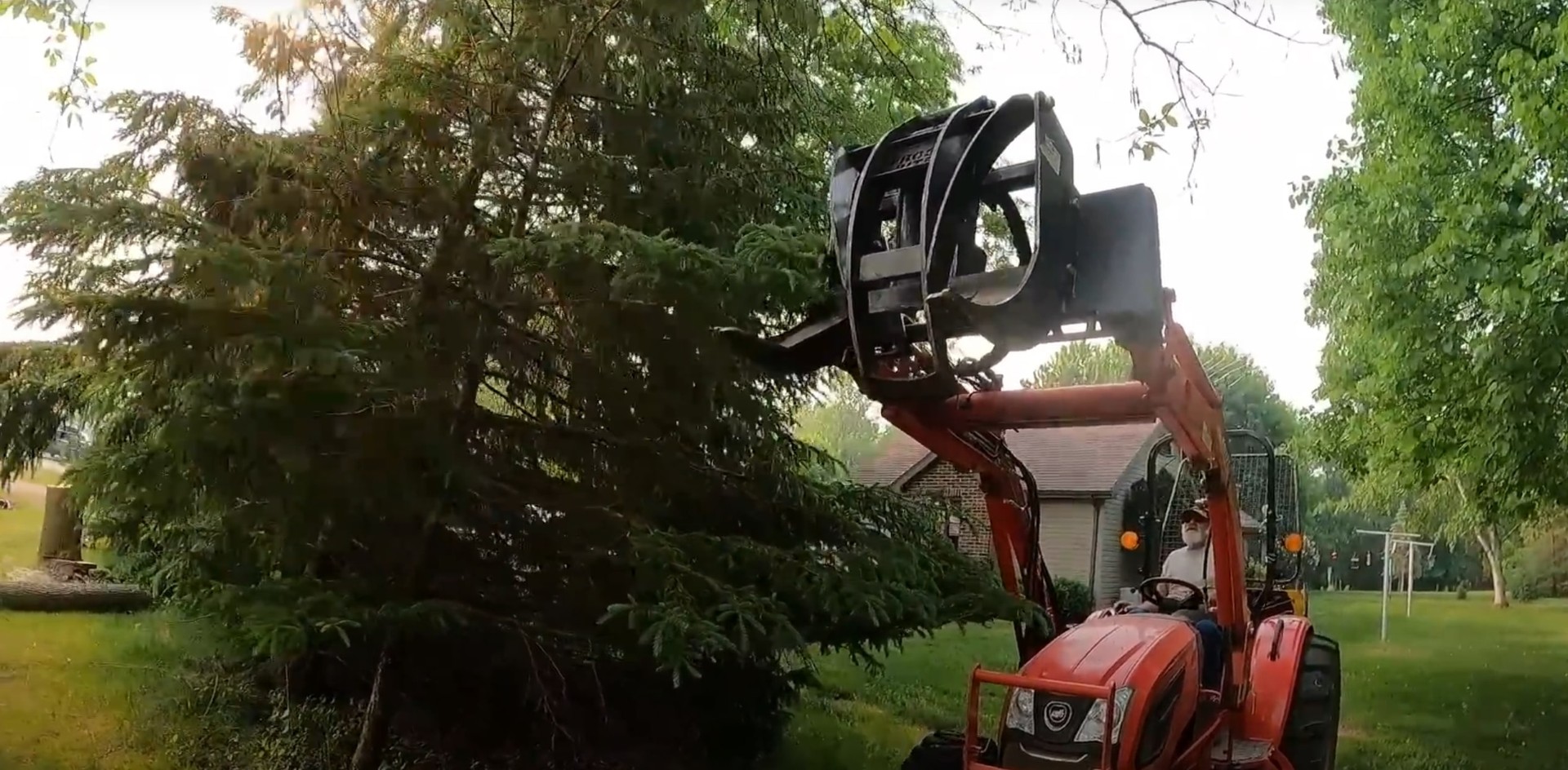 Professional tree removal equipment in action Tree grappler equipment removing large tree sections